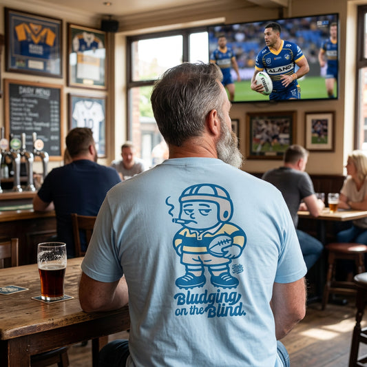 Man sitting in bar wearing a Footy Head Tee Shirt called Bludging On The Blind NRL T Shirt